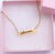 Personalized gold engraved nameplate necklace.